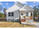 Charming white house with brick steps, wooden porch railing, and landscaping at 109 E Broad St, Salisbury, NC 28144