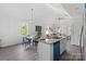 Modern kitchen island with granite countertops and a teal dishwasher at 109 E Broad St, Salisbury, NC 28144