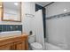 Stylish bathroom with a rustic vanity, modern sink and a shower/tub with a blue and white tile accent at 125 Chestnut Tree Rd, Mooresville, NC 28117