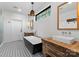 Chic bathroom featuring dual vanities, a modern soaking tub, elegant fixtures, and stylish tile flooring at 125 Chestnut Tree Rd, Mooresville, NC 28117