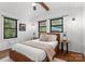 Bright bedroom with hardwood floors and two windows illuminating the queen bed, bedside tables, and decor at 125 Chestnut Tree Rd, Mooresville, NC 28117