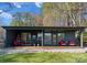 Modern home with a covered porch featuring stylish seating and a well-manicured lawn at 125 Chestnut Tree Rd, Mooresville, NC 28117