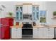 Charming kitchen with white and blue cabinets, butcher block counters, and retro red refrigerator at 125 Chestnut Tree Rd, Mooresville, NC 28117