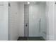 Modern shower with sleek glass enclosure, stylish tile design, and rainfall shower head at 125 Chestnut Tree Rd, Mooresville, NC 28117