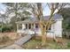 Charming white cottage with a porch, ramp, and landscaping at 160 Brookwood Ne Ave, Concord, NC 28025