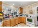 Kitchen with wood cabinets, appliances, and window at 160 Brookwood Ne Ave, Concord, NC 28025