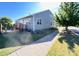 Well-kept backyard with a sunroom and a sidewalk near a green lawn at 1605 Appledale Ct # 116, Fort Mill, SC 29715