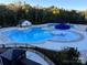 Community swimming pool with a splash pad and leisure area, surrounded by trees at 1605 Appledale Ct # 116, Fort Mill, SC 29715