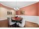 Bright dining room boasts chair rail, hardwood floors, chandelier, and a stylish table at 1605 Appledale Ct # 116, Fort Mill, SC 29715