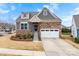 Charming home with a stone and gray siding, complemented by a two-car garage and well-maintained landscaping at 1605 Appledale Ct # 116, Fort Mill, SC 29715