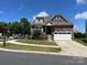 Charming home featuring stone accents, two-car garage, and a well-manicured lawn at 1605 Appledale Ct # 116, Fort Mill, SC 29715