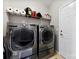 Functional laundry room equipped with front-load washer and dryer, and shelving for storage at 1605 Appledale Ct # 116, Fort Mill, SC 29715