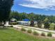 View of a community pool with umbrellas and surrounding landscaping at 1605 Appledale Ct # 116, Fort Mill, SC 29715