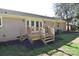 Backyard patio area with a raised wooden deck and steps leading to the grassy yard at 1721 Edgewater Dr, Charlotte, NC 28210