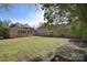 Spacious backyard with lush greenery, including a wooden deck attached to the house at 1721 Edgewater Dr, Charlotte, NC 28210