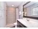 Bathroom features tiled shower and flooring, and a dark wood vanity at 1721 Edgewater Dr, Charlotte, NC 28210