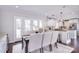 Bright dining room with a wooden table, elegant chairs, and a view into the kitchen area at 1721 Edgewater Dr, Charlotte, NC 28210