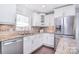 Bright kitchen with granite countertops, stainless steel appliances, and white cabinets at 1721 Edgewater Dr, Charlotte, NC 28210