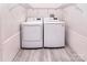 Laundry area features side-by-side washer and dryer units with storage shelves at 1721 Edgewater Dr, Charlotte, NC 28210