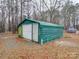 Green metal garage with white door, located in wooded area at 177 Jim Hanna Ln # 4510, Wadesboro, NC 28170