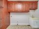 Laundry room with wood cabinets and tile floor at 177 Jim Hanna Ln # 4510, Wadesboro, NC 28170