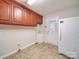 Laundry room with wood cabinets, utility sink and refrigerator at 177 Jim Hanna Ln # 4510, Wadesboro, NC 28170