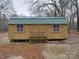 Wooden storage shed with green roof, offering extra storage at 177 Jim Hanna Ln # 4510, Wadesboro, NC 28170