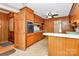 Long kitchen with wood cabinets and tile floor at 1801 Windsor Dr, Lancaster, SC 29720