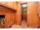 Laundry room with wood paneling and access to bathroom at 1801 Windsor Dr, Lancaster, SC 29720