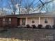 Brick and pink exterior of a ranch home with a covered porch and landscaping at 190 Nine Patch Ln, Taylorsville, NC 28681