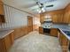 Kitchen with oak cabinets, tile floor and view into adjacent room at 190 Nine Patch Ln, Taylorsville, NC 28681