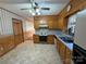 Kitchen with oak cabinets, tile floor, and a view of dining area at 190 Nine Patch Ln, Taylorsville, NC 28681