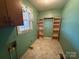 Laundry room with tile flooring, shelving, and window at 190 Nine Patch Ln, Taylorsville, NC 28681