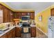 Kitchen with wood cabinets, stainless steel appliances, and vinyl flooring at 1968 12Th Street Ne Pl, Hickory, NC 28601