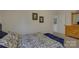 A well-lit bedroom featuring a decorative bedspread and a wooden dresser at 2001 Yellow Daisy Dr, Matthews, NC 28104