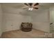 Carpeted bedroom with a ceiling fan, a comfy chair, and neutral paint at 2001 Yellow Daisy Dr, Matthews, NC 28104