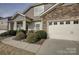 A lovely home with stone accents, a two car garage, and manicured shrubs at 2001 Yellow Daisy Dr, Matthews, NC 28104