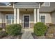 A welcoming front entryway with large white columns and a black front door with wreath at 2001 Yellow Daisy Dr, Matthews, NC 28104