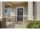 Inviting front porch featuring a black door with wreath and chairs and table seating area at 2001 Yellow Daisy Dr, Matthews, NC 28104