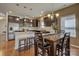 Kitchen with stainless steel appliances, wood floors, a central island with granite counter and dark wood table at 2001 Yellow Daisy Dr, Matthews, NC 28104