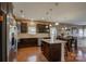 A kitchen with dark wood cabinetry, granite countertops, stainless steel appliances and a central island at 2001 Yellow Daisy Dr, Matthews, NC 28104