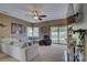 Living room featuring a ceiling fan, neutral paint, and a sliding glass door to the yard at 2001 Yellow Daisy Dr, Matthews, NC 28104