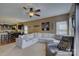 Spacious living room with a large sectional sofa, ceiling fan, and view into the kitchen at 2001 Yellow Daisy Dr, Matthews, NC 28104