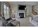 Living room with a fireplace, large TV, and sliding glass door to the yard at 2001 Yellow Daisy Dr, Matthews, NC 28104