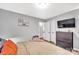 Bedroom with neutral walls, dark dresser, and mounted TV at 2025 Ibis Ct, Charlotte, NC 28205