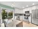 Modern kitchen with white cabinets, stainless steel appliances, and marble top table at 2027 Ibis Ct, Charlotte, NC 28205