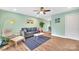 Light and airy living room with a gray couch and light wood floors at 2027 Ibis Ct, Charlotte, NC 28205