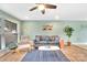 Comfortable living room showcasing a gray couch and a ceiling fan at 2027 Ibis Ct, Charlotte, NC 28205