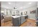 Modern kitchen with island, stainless steel appliances, and hardwood floors at 203 Grandin Rd # 3, Charlotte, NC 28208