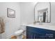 Modern powder room with blue vanity, white countertop, and stylish mirror at 203 Grandin Rd # 3, Charlotte, NC 28208